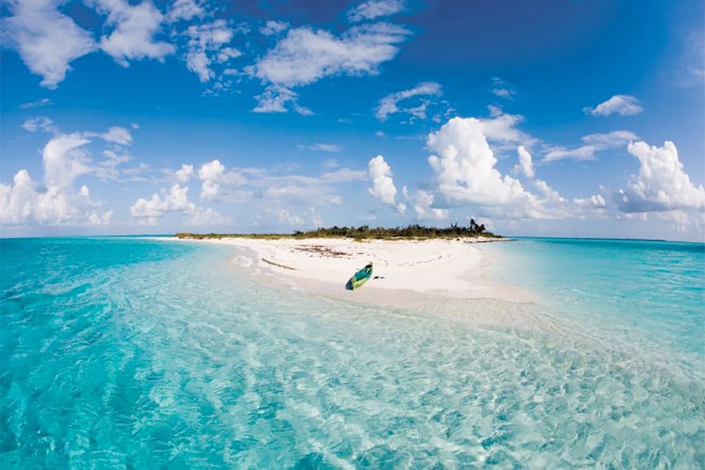 A widescreen photograph of a Bahamas beach.